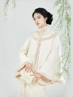 Apricot modern Song Dynasty Hanfu embroidered cape close-up with golden floral embroidery stand collar and traditional frog button closures