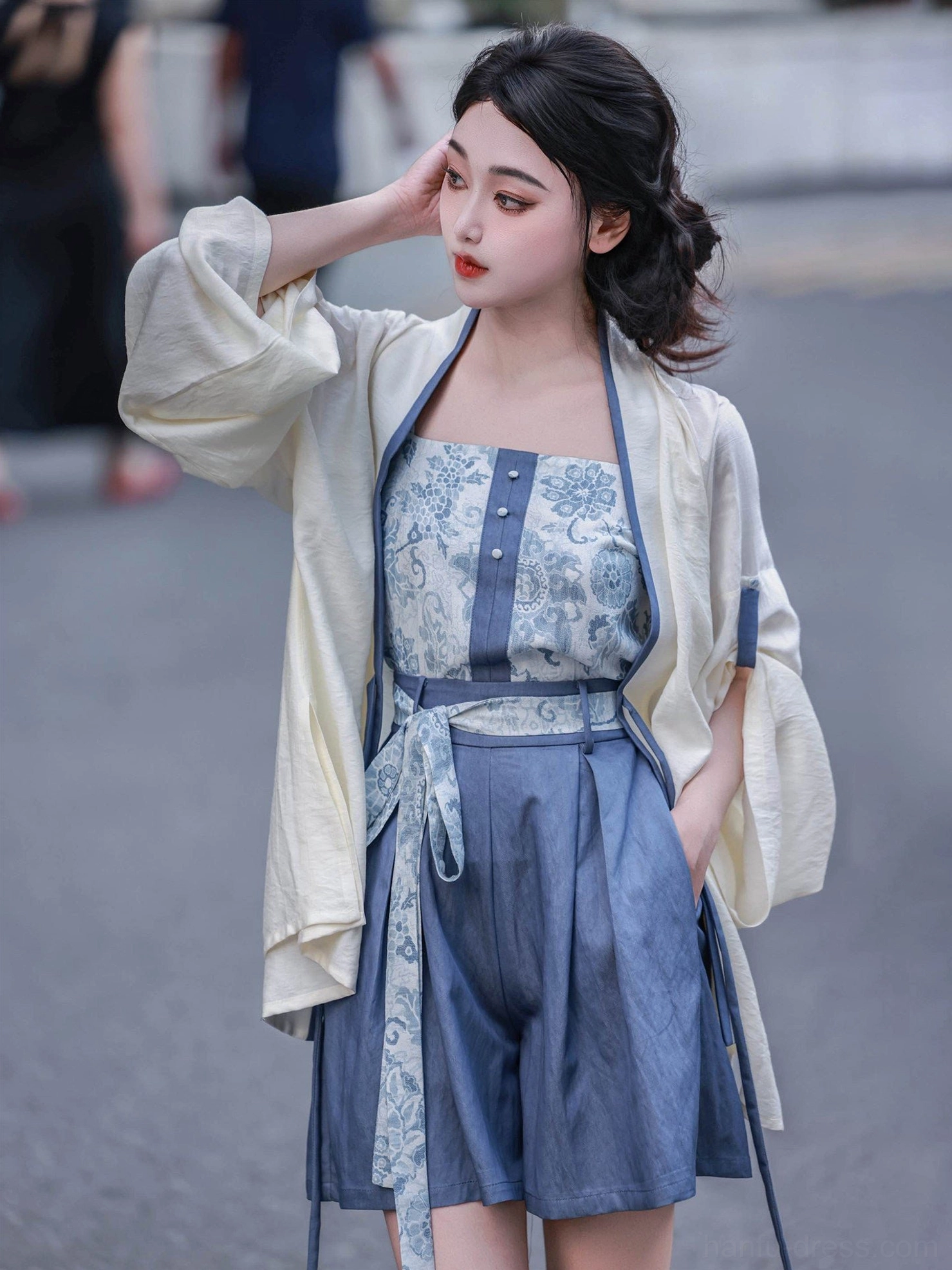 Close view of modern Song Dynasty Hanfu blue floral camisole, loose ivory cardigan and high-waisted shorts with sash