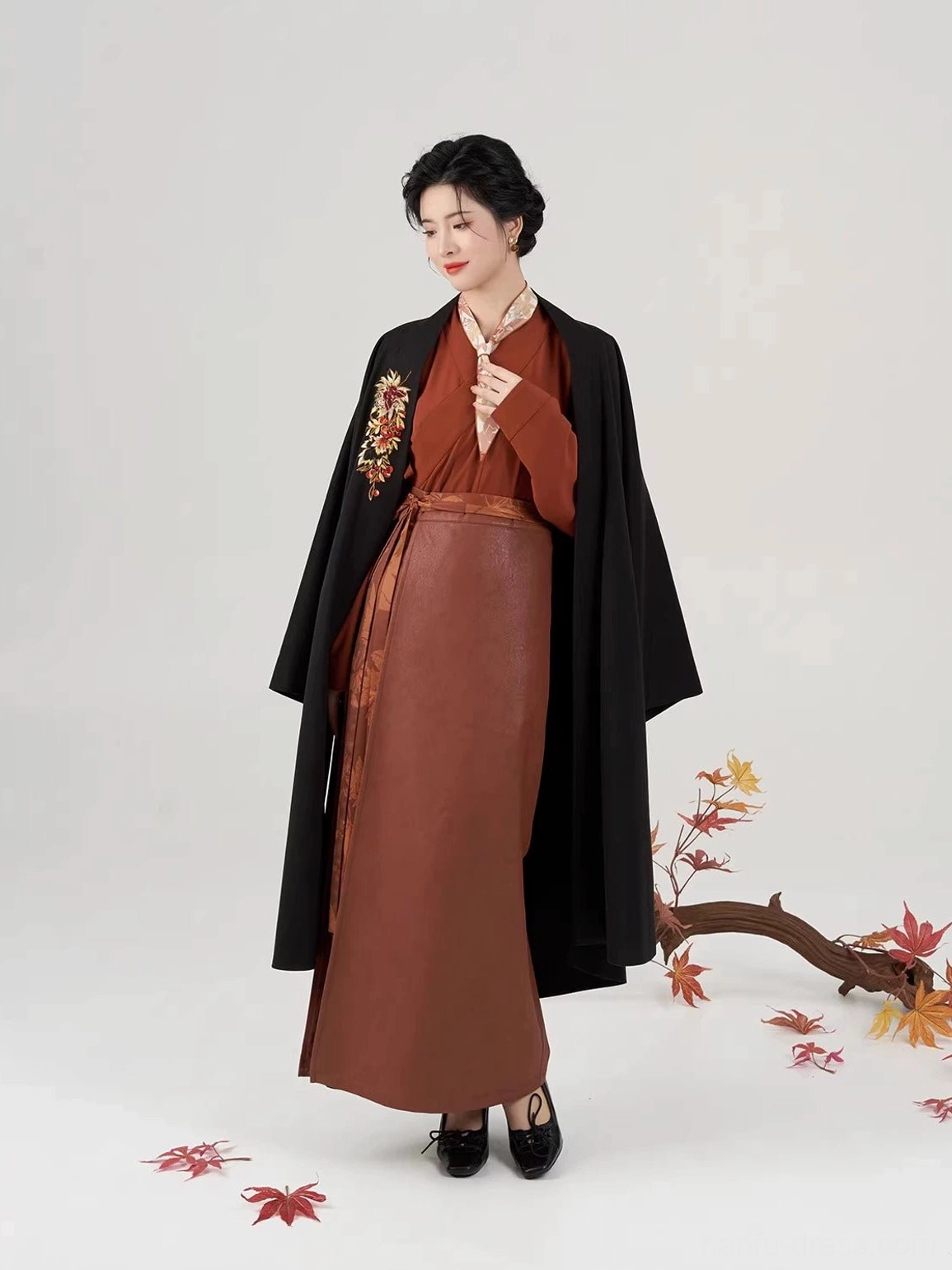 Modern Song Dynasty hanfu full set shown in a three-quarter side view with a long black embroidered jacket, rust-red inner layers, and autumn maple leaf studio styling