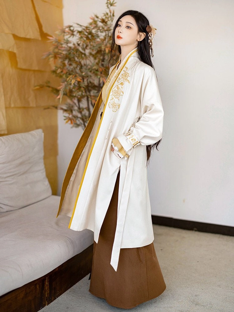 Full body modern Song Dynasty Hanfu set with cream outer robe, mustard cross collar top, and dark brown high waisted spiral wrap skirt