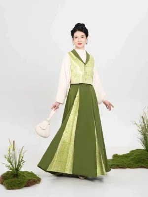 Three-quarter side view of a modern Song Dynasty hanfu outfit with green color-block pleated maxi skirt, tailored vest, cream top, and round white handbag
