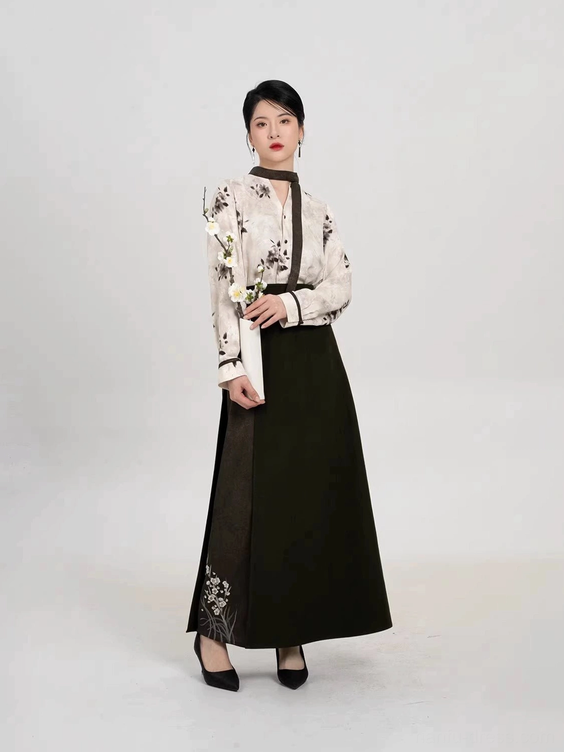 Modern Song Dynasty Hanfu two-piece set with ivory ink plum long sleeve top and dark olive spiral skirt styled with a plum blossom branch