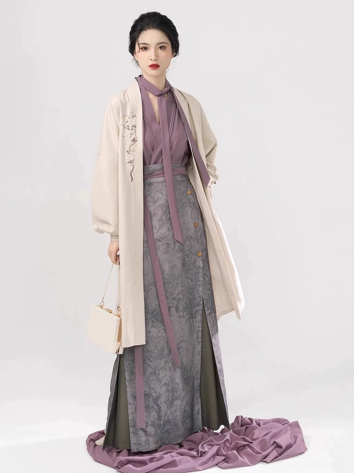 Modern Song Dynasty Hanfu set showing delicate floral embroidery on the ivory outer jacket over purple top and grey printed skirt