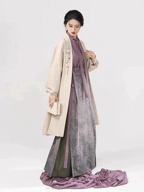 Side front view of modern Song Dynasty Hanfu layered outfit with ivory jacket, grey pleated wrap skirt, and side slit detail