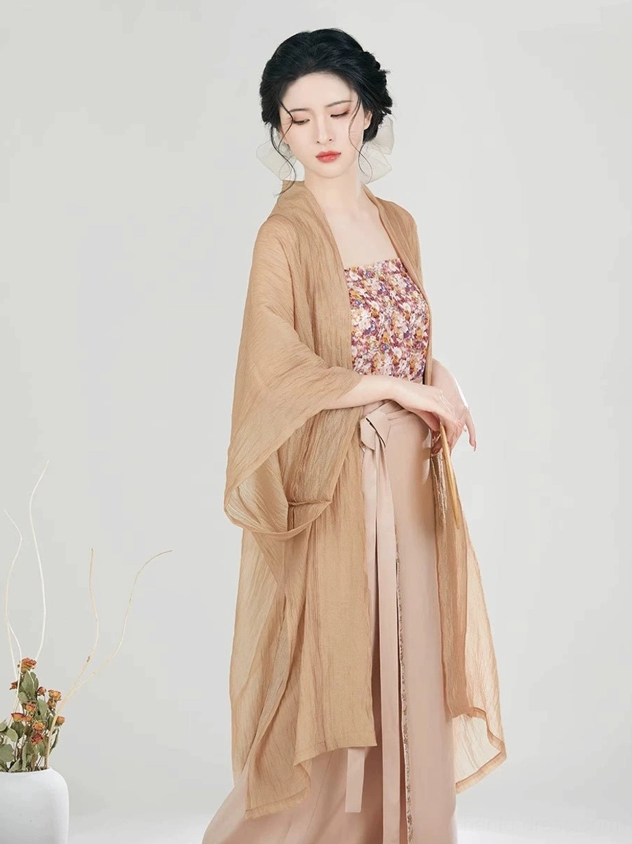 Front view of a modern Song Dynasty Hanfu outfit layered with tan beizi jacket, floral camisole, high-waisted wrap skirt, and soft traditional hairstyle