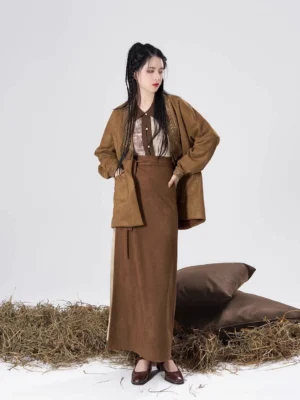 Three-quarter front view of a modern Song Dynasty Hanfu outfit with a brown open coat, high-waisted maxi wrap skirt, and coordinated top