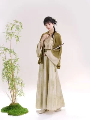 Three-quarter view of a modern Chinese-style Song Dynasty Hanfu outfit with olive green outer robe, flowing beige skirt, tied waist, and paper fan