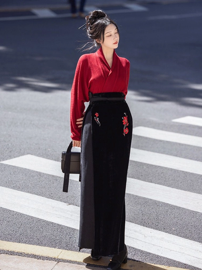 Side view of modern Song Dynasty Hanfu two piece set with red long sleeve top, black floral embroidered skirt, and handbag