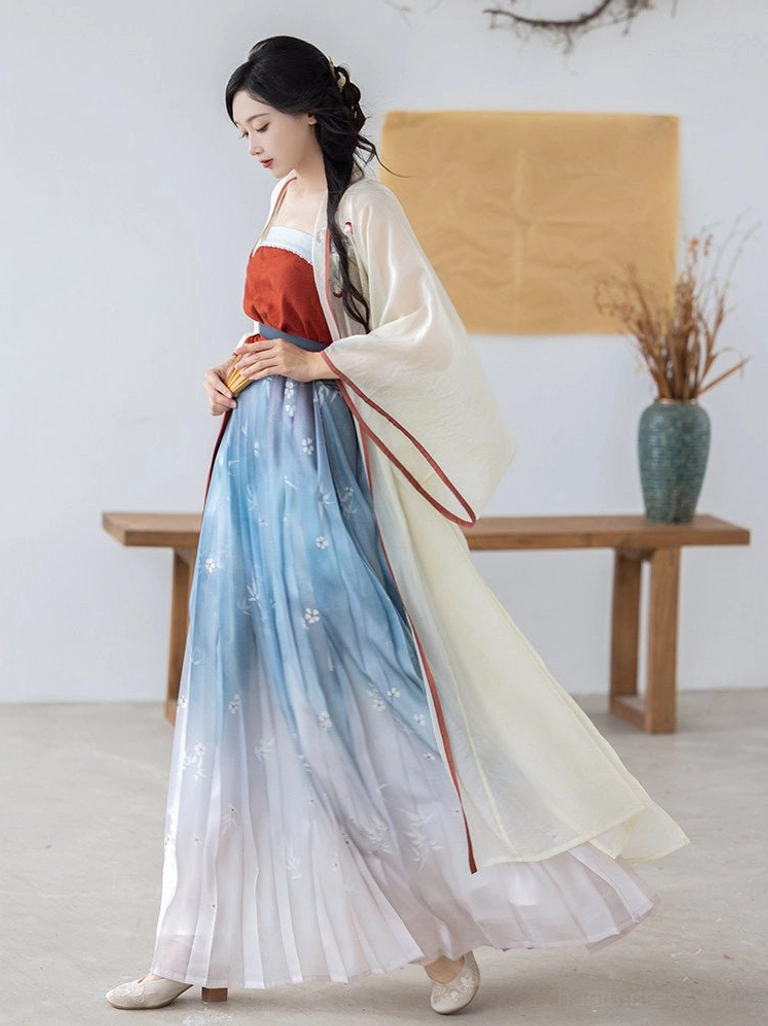 Full body side view of a woman wearing a modern Song Dynasty Hanfu set with cream embroidered cardigan, burgundy camisole, and blue white gradient pleated skirt