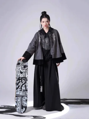 Front view of a modern Song Dynasty Hanfu set featuring a grey and black embroidered dragon jacket, black hooded sweater, and flowing wide-leg pants