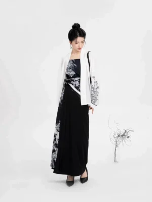 Three-quarter side view of modern Song Dynasty Hanfu outfit showing the layered camisole, winged sleeve top, asymmetrical floral panel, and flowing wrap skirt