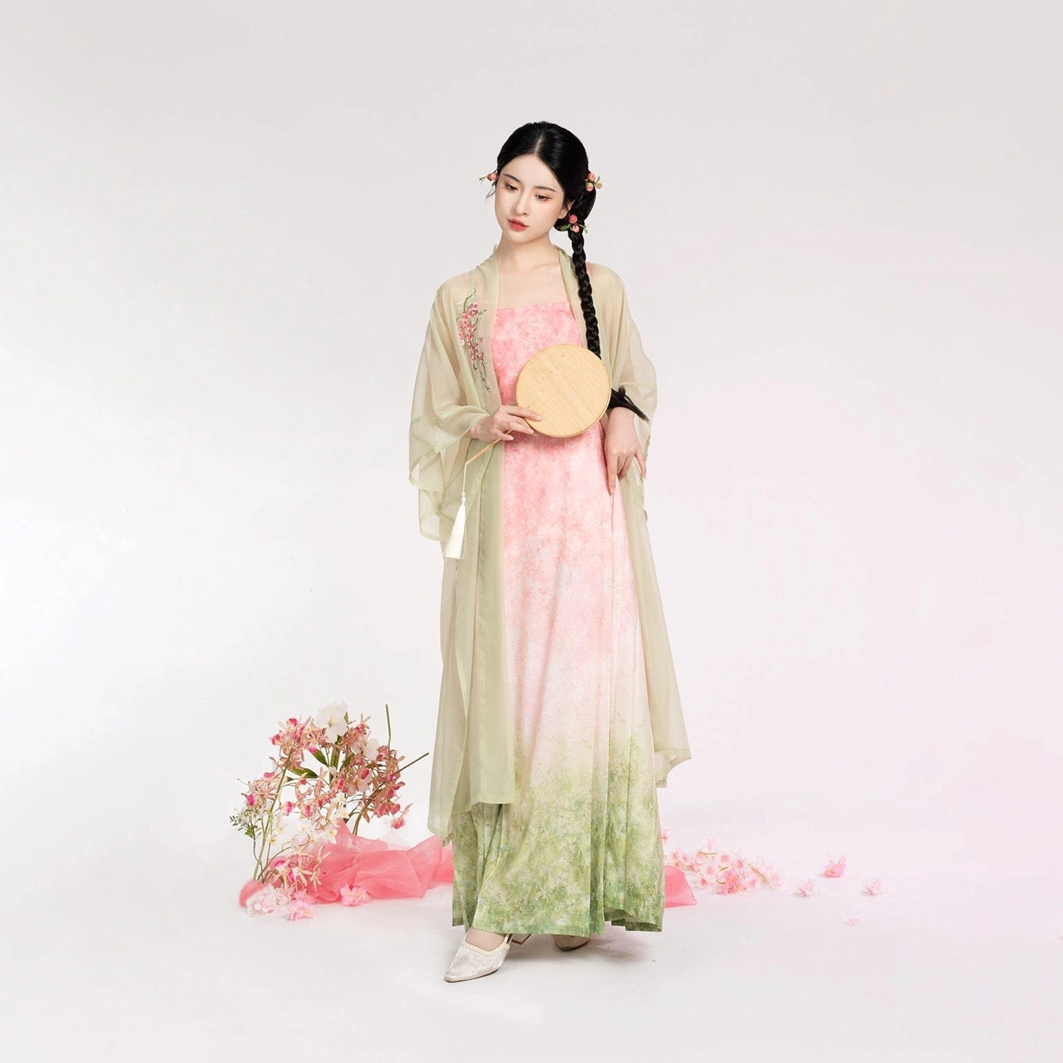 Full-body front view of modern Song Dynasty Hanfu with a translucent beizi coat, pink-to-green gradient dress, round woven fan, and white traditional footwear