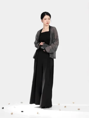 Three-quarter front view of a modern Song Dynasty Hanfu winged-sleeve top in dark grey sheer woven fabric