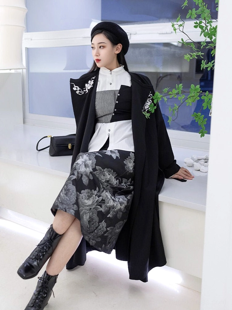 Modern Song Dynasty inspired Hanfu outfit with white stand collar shirt, black floral embroidered coat, grey rose print midi wrap skirt, beret, combat boots, and handbag