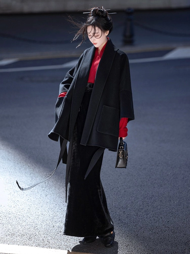 Modern Song style Hanfu outfit layered with a black wool coat, red cross collar top, and long black skirt for contemporary streetwear