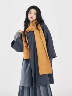 Front view of modern Tang Dynasty Hanfu outfit with charcoal overcoat striped skirt and mustard scarf