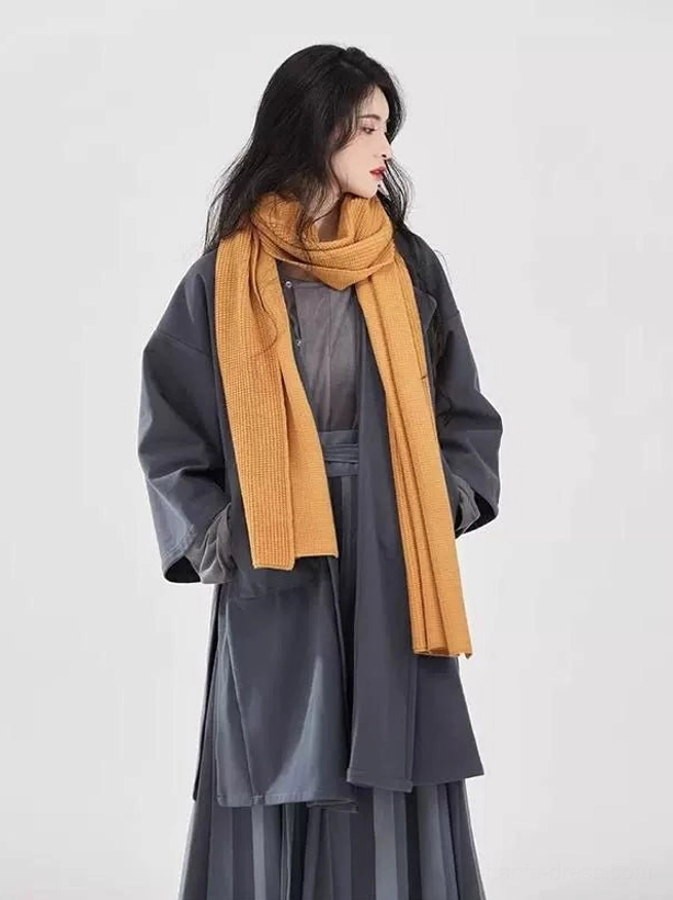 Right profile view of charcoal modern Tang Dynasty Hanfu set with long overcoat and two tone striped skirt