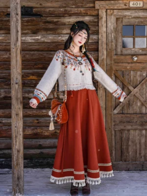 Modern Tang Dynasty Hanfu embroidered ivory knit sweater and rust red wrap skirt full set front view in snowy outdoor setting