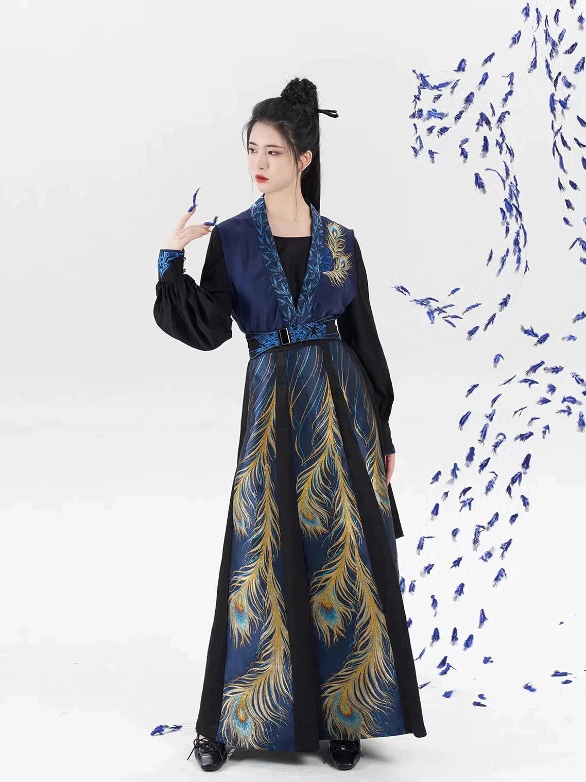 Front three-quarter view of a modern Tang Dynasty hanfu set with fitted waist, navy beizi overlay, and vertical peacock feather skirt patterns