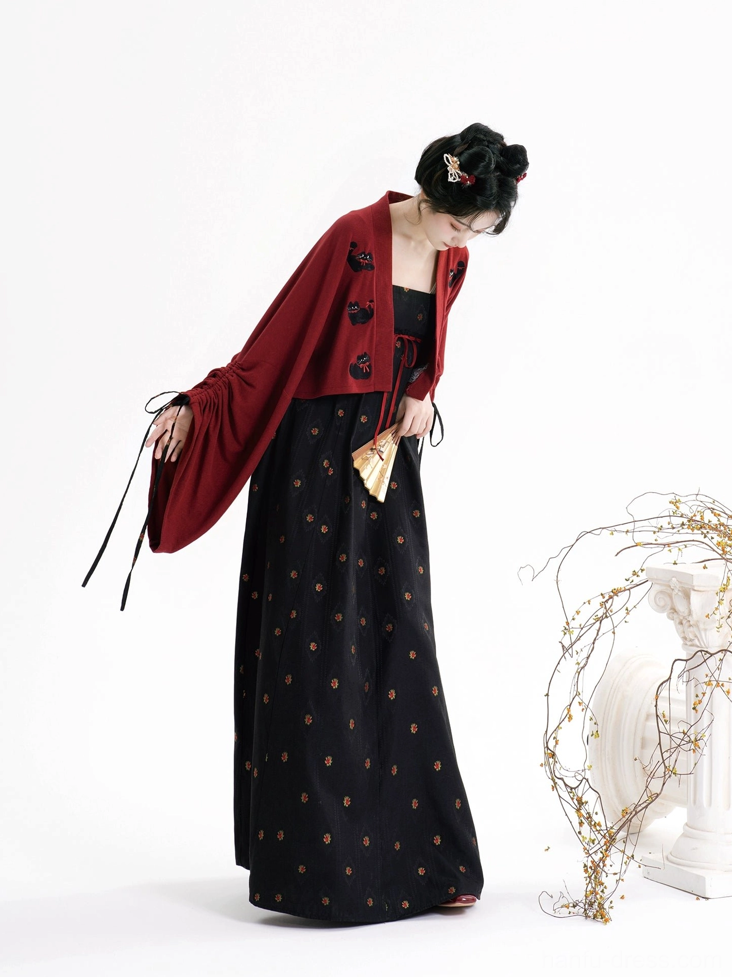 Side view of modern Tang Dynasty Hanfu black floral slip dress and burgundy cat embroidered cropped cardigan