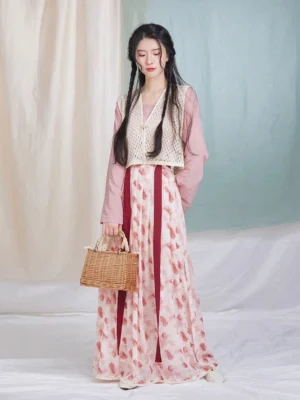 Front view of a complete modern Tang Dynasty hanfu outfit with dusty pink round-collar top, crochet beizi overlay, raspberry pleated wrap skirt, and wine-red waist ties