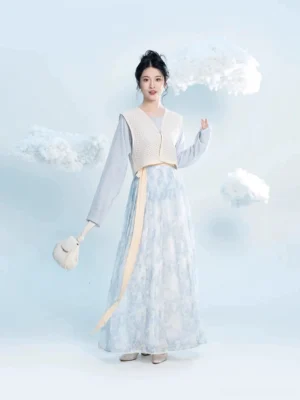 Modern Tang Dynasty Hanfu three piece set with sky blue round collar top beige Beizi overlay and blue floral pleated wrap skirt shown on a model