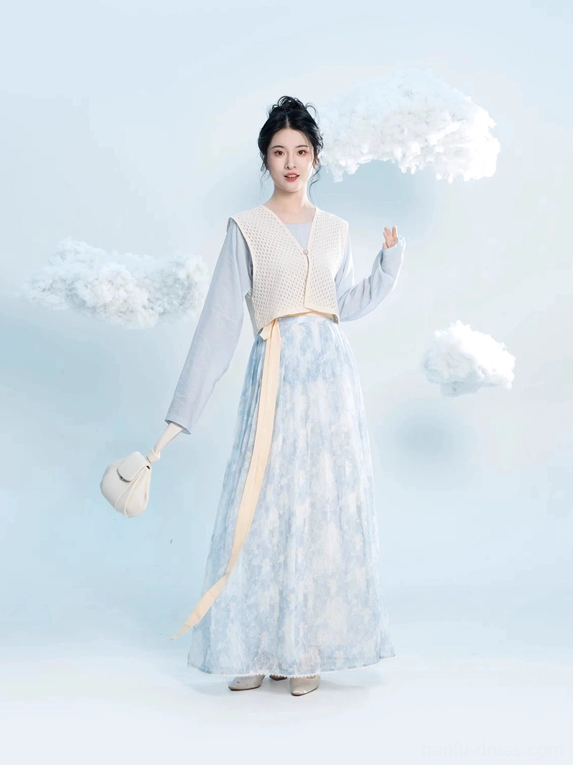 Modern Tang Dynasty Hanfu three piece set with sky blue round collar top beige Beizi overlay and blue floral pleated wrap skirt shown on a model