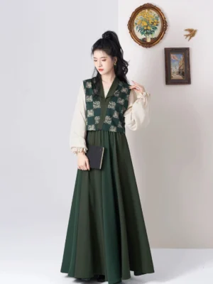Full body front view of a modern Tang Dynasty Hanfu outfit with dark green floral jacquard Beizi, off white lantern sleeve top, and flowing eight panel maxi skirt