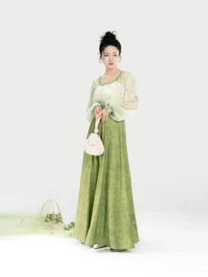 Modern Tang Dynasty Hanfu set shown from the front with an off-white sweetheart-collar top, sage green pleated eight-panel skirt, and elegant lightweight drape