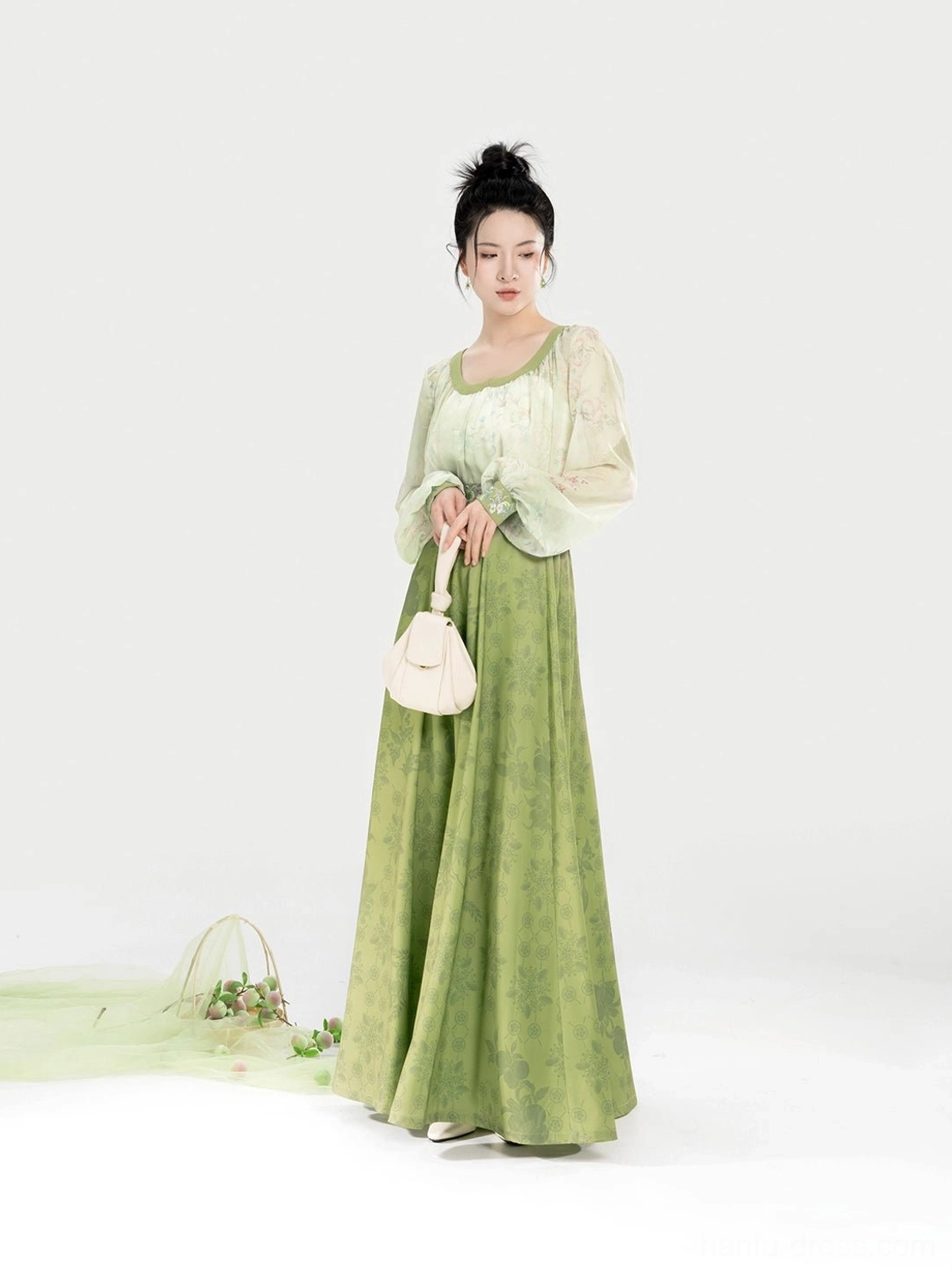 Modern Tang Dynasty Hanfu set shown from the front with an off-white sweetheart-collar top, sage green pleated eight-panel skirt, and elegant lightweight drape