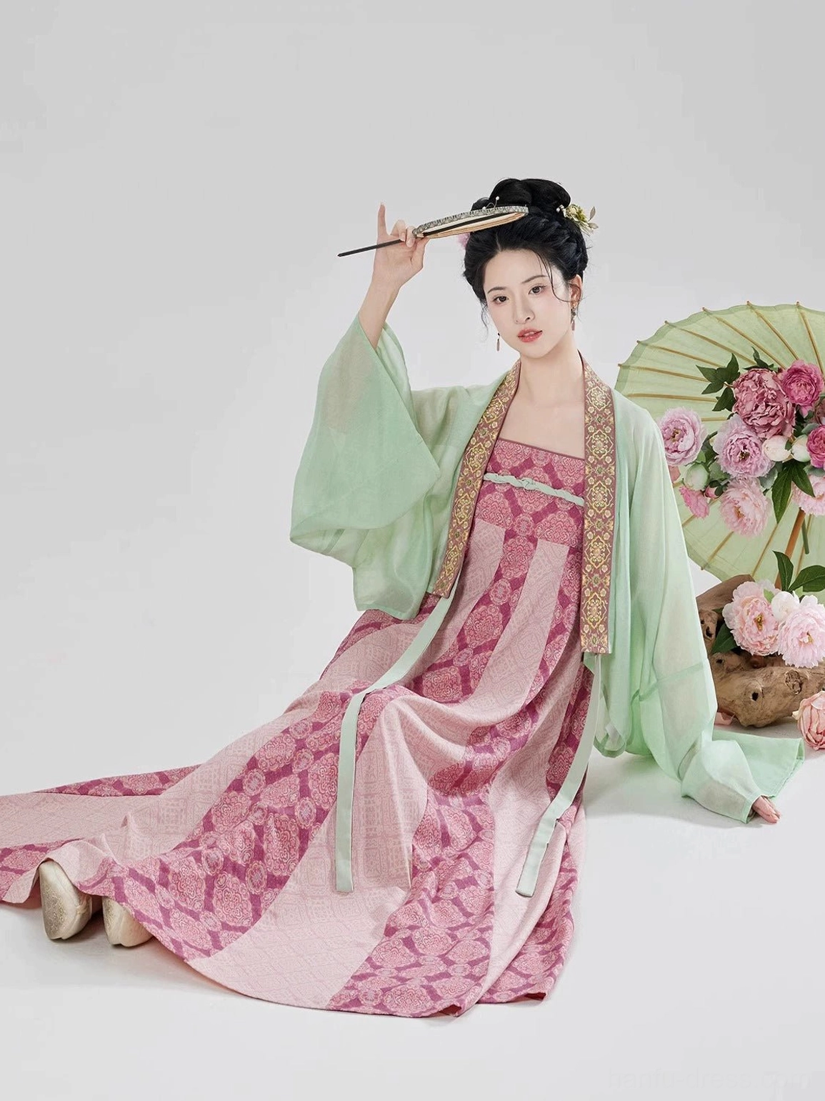 Modern Tang Dynasty Hanfu outfit shown in a seated pose with the long eight-panel skirt draping across the floor