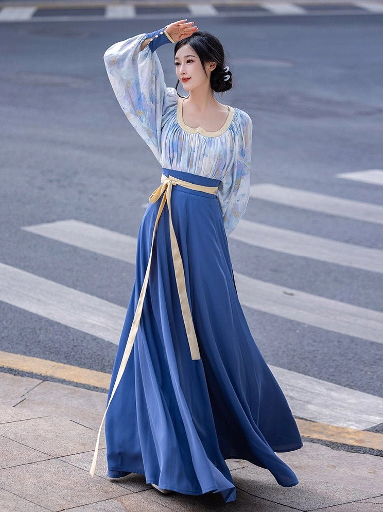 Modern Tang Dynasty Hanfu two piece outfit with Van Gogh inspired blue watercolor top lantern sleeves navy wrap skirt and beige waist sash shown from the front