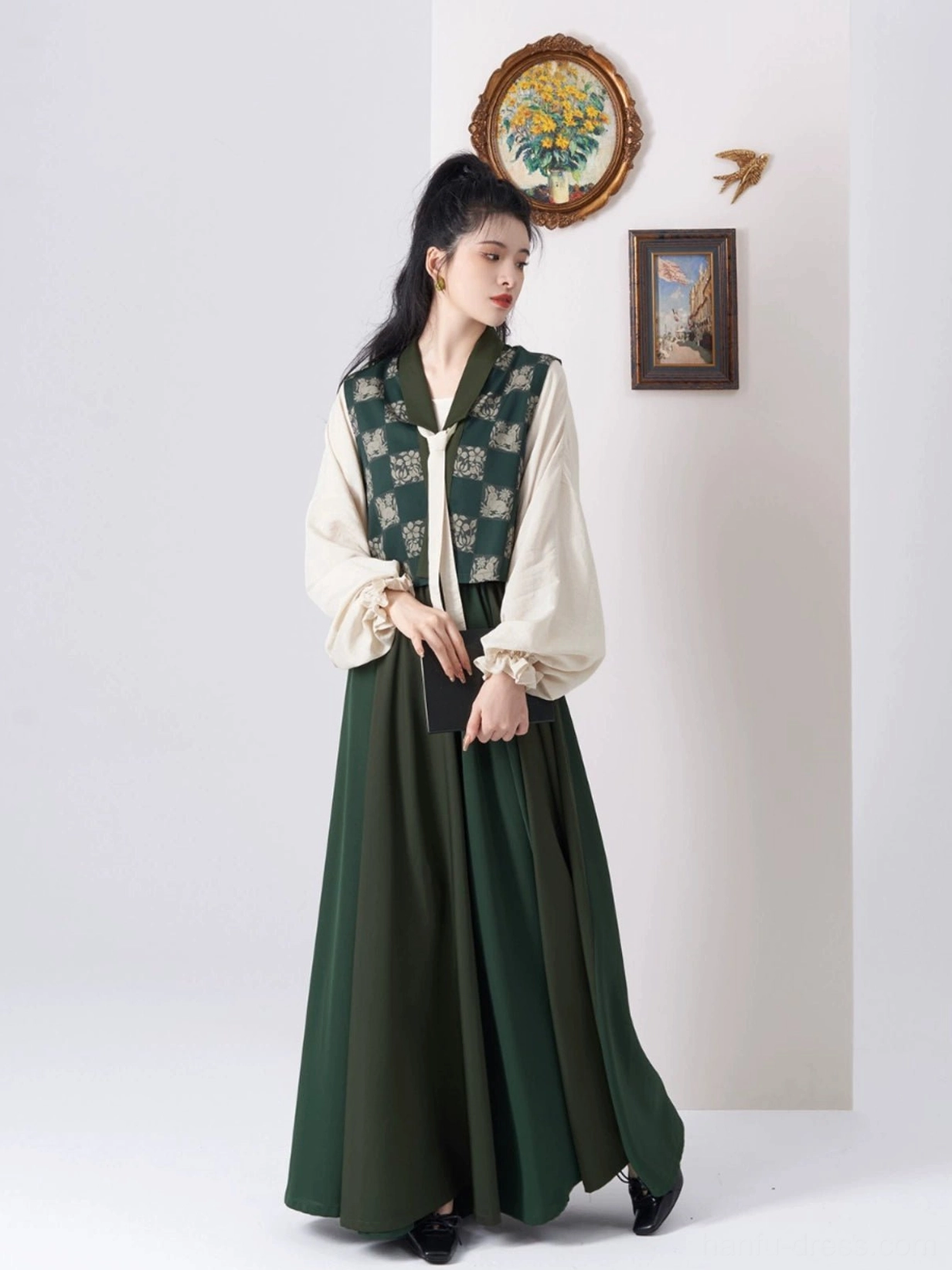 Three quarter view of a modern Tang style Hanfu set with dark green Beizi overlay, light top, flowing maxi skirt, and black low heel shoes