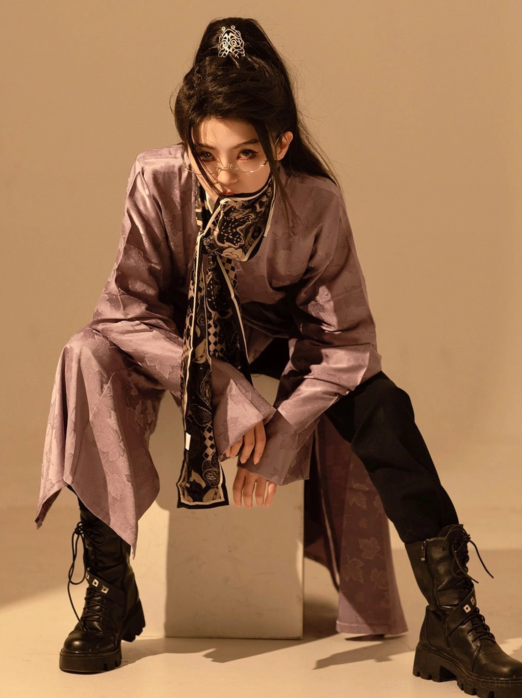 Low-angle view of a modern taro purple Hanfu robe with split floor-length design, matching scarf, black trousers, and combat boots