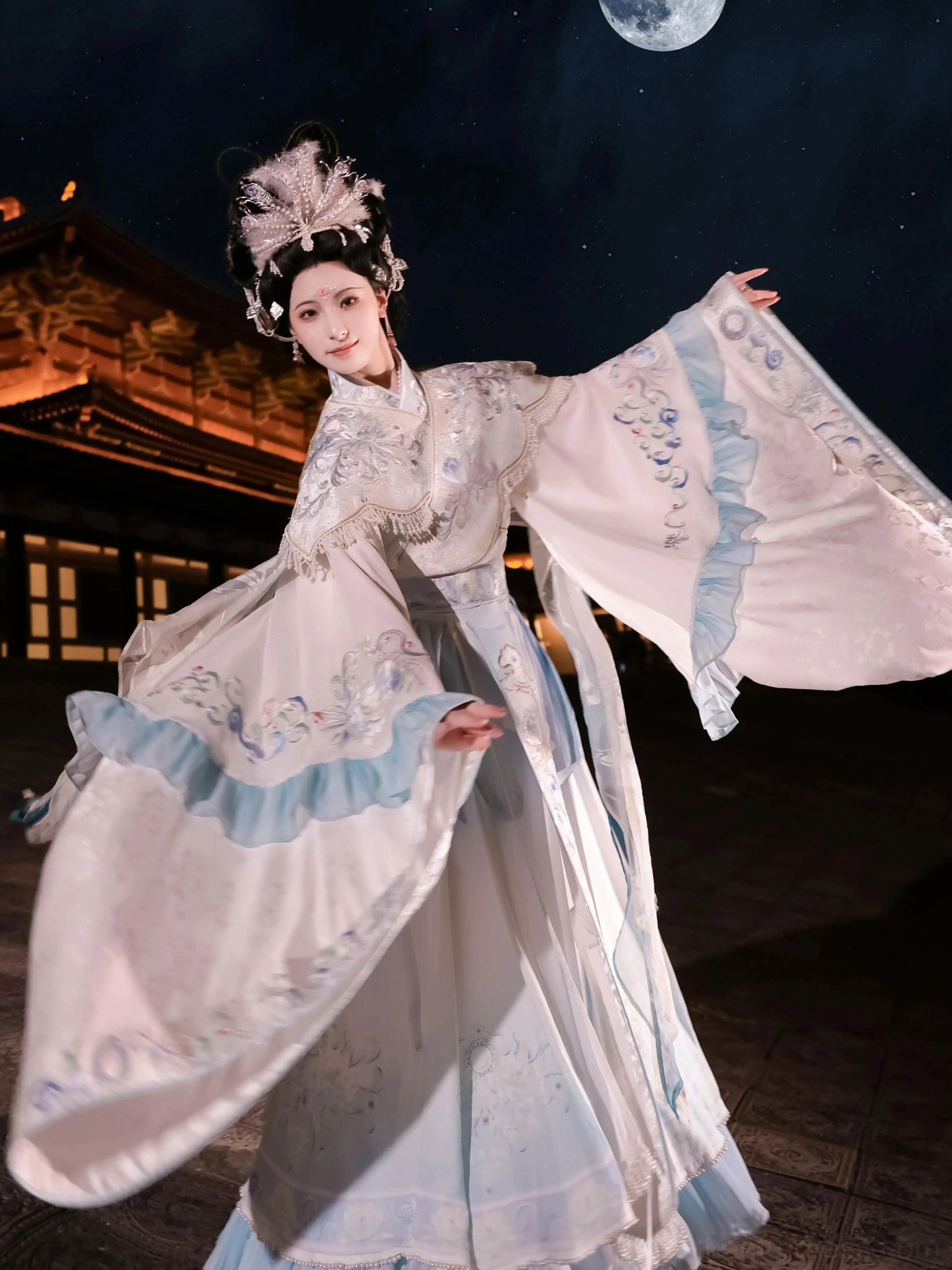 Moon Goddess embroidered Qiyao Ruqun Hanfu photographed at night with a full moon, flowing wide sleeves, pale blue embroidery, and xianxia styling