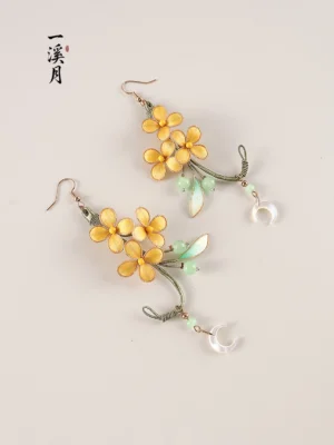 Pair of Chinese Hanfu osmanthus earrings featuring golden blossoms green leaves wrapped vine branches and crescent moon drop pendants