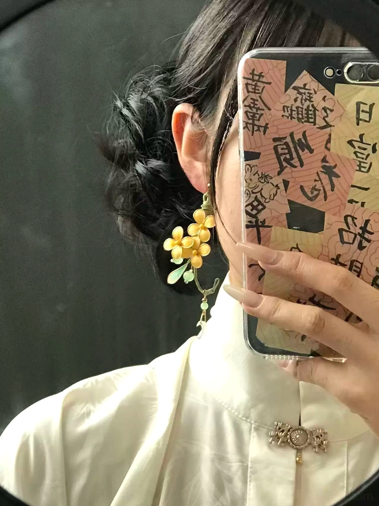 Model wearing a moon laurel osmanthus drop earring with a white stand collar Hanfu inspired top indoors