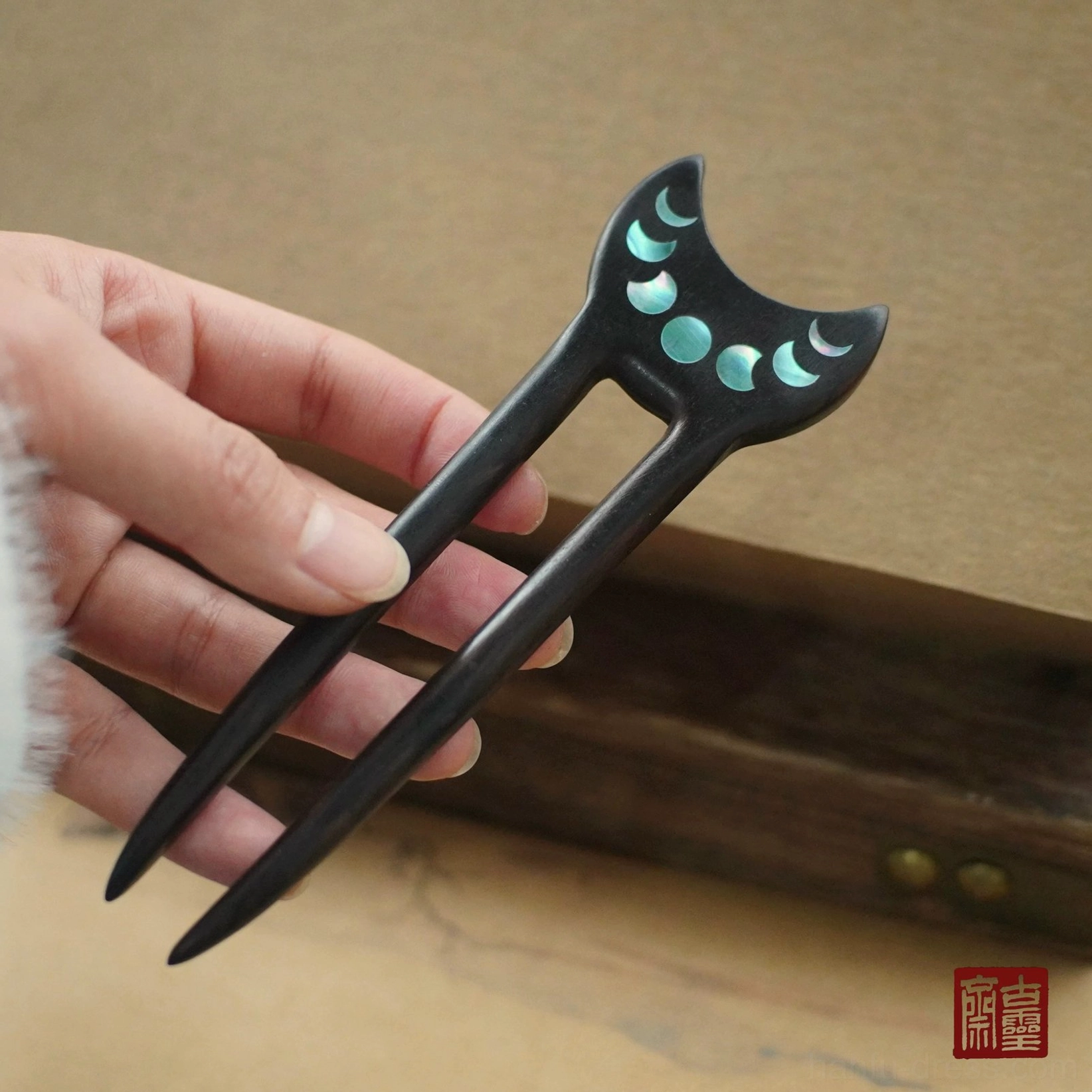Handmade dual-pronged moon phase Chinese hair stick with cyan lunar inlays and matte black wooden body for Hanfu hairstyles