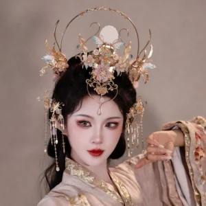 Moon Song Hanfu hair accessories set worn by model with gold filigree crown pink flowers blue butterflies and dangling tassels