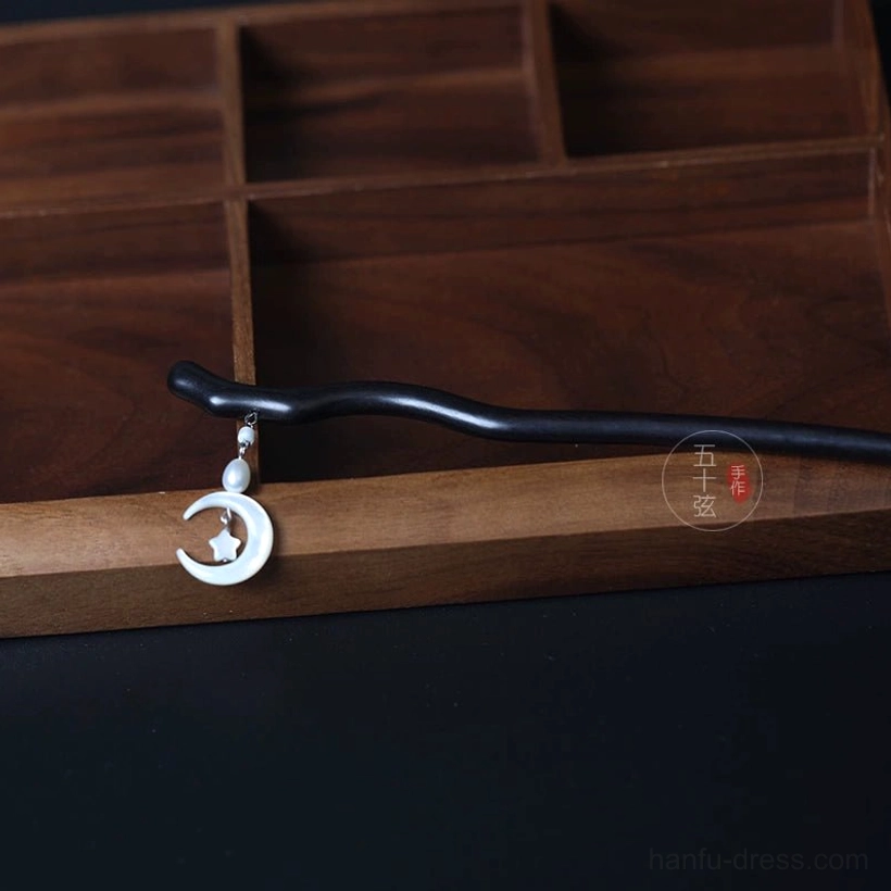 Side view of moon and star Hanfu hair accessory with slim dark hair stick and elegant dangling pearl celestial charm