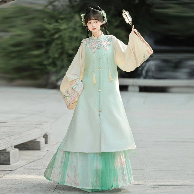 Mint green Moonlit Flowers Ming Dynasty Hanfu full set with cream bijia vest, tassel pendants and printed pleated skirt by water