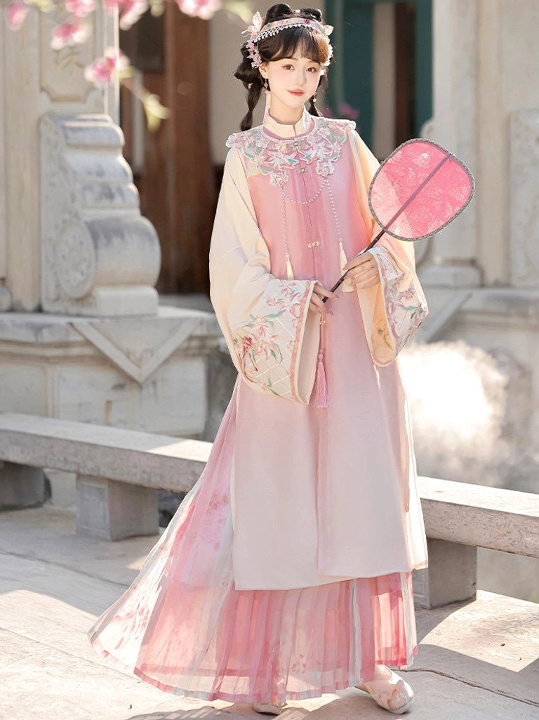 Side back view of pink Ming Dynasty Hanfu outfit showing layered gradient pleated skirt, embroidered cuffs and flowing robe