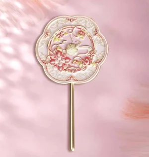 Moonlit lotus Chinese hand mirror with golden full moon, auspicious clouds, blush pink floral frame, and gold-toned handle on a soft pink background