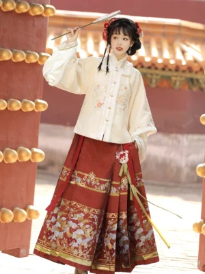Front view of Moonlit Night Ming dynasty Hanfu Chinese New Year outfit with embroidered cream coat red horse-face skirt and folding fan