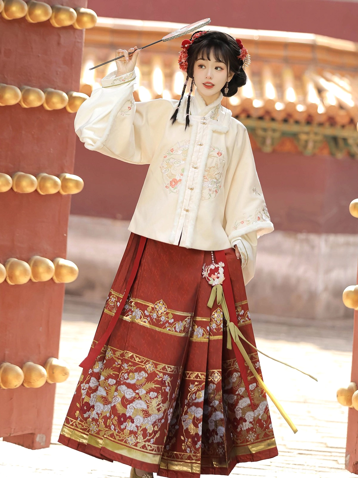 Front view of Moonlit Night Ming dynasty Hanfu Chinese New Year outfit with embroidered cream coat red horse-face skirt and folding fan