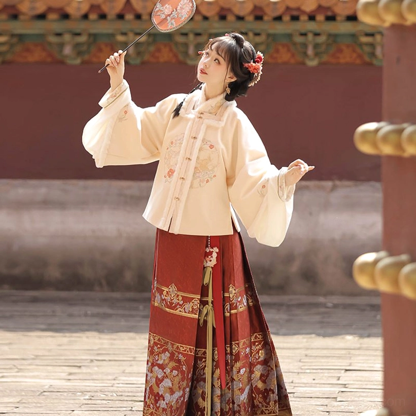 Three-quarter view of Moonlit Night Ming style Chinese New Year Hanfu with cream embroidered outerwear and red gold decorated mamian skirt