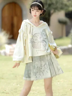 Morning Garden modern Hanfu hoodie and sage green mamian skirt set shown in a full body front view outdoors