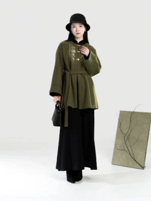 Three-quarter view of moss green Chinese-style Hanfu cardigan with brass-style buttons, relaxed A-line cut, stand collar, and embroidered chest detail