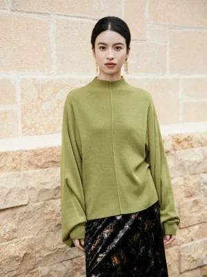 Front view of a moss green modern Chinese style cashmere blend knitted sweater with stand collar, relaxed loose fit, oversized sleeves, and ribbed knit texture