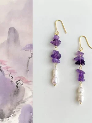 Chinese Hanfu jewelry amethyst pearl drop earrings shown in a front flat lay with stacked purple stones and white freshwater pearls